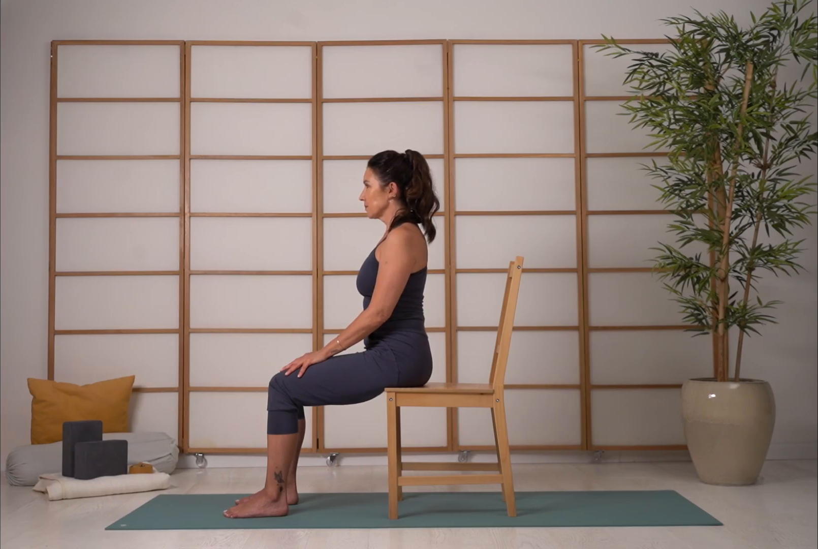 A teacher seated on a chair in the Vinys studio